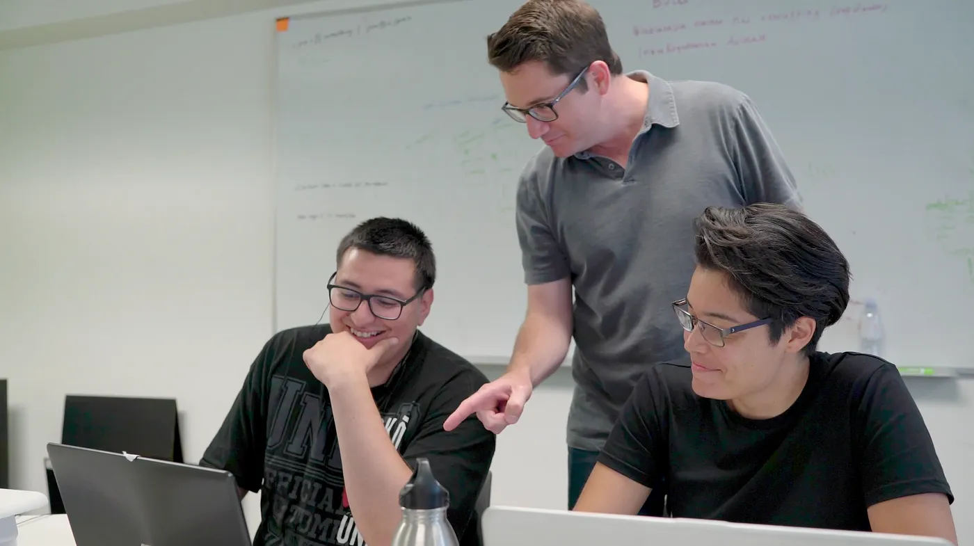 Image of a Sabio instructor talking to a student